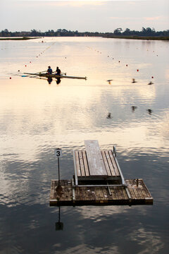 Rowers training on a lake in the evening