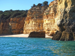 Coastline of the Algarve coast in Portugal with tall cliffs, hidden grottoes and idyllic bays