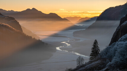 Golden sunrise over a misty mountain valley