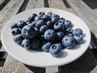 A light breakfast outside. A tasty and juicy berry. Many shades of blue. Blueberry.