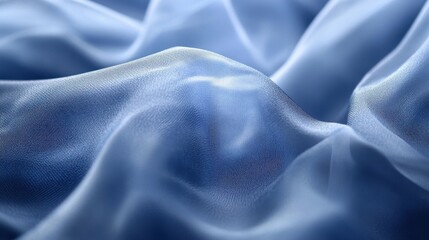 Obraz premium Abstract blue silk fabric waves texture with soft light and elegant flow patterns