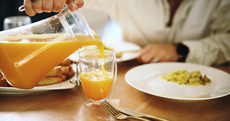Pouring, juice and person with breakfast, home and beverage with benefits of vitamin c, hands or...