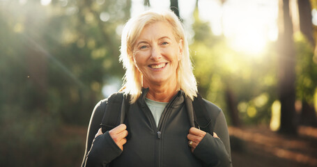 Portrait, mature and happy woman in forest for hiking in adventure, nature or retirement. Smile,...