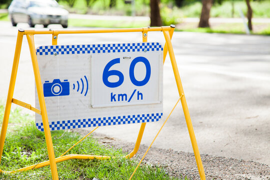 Police speed camera 60 km speed zone sign beside highway
