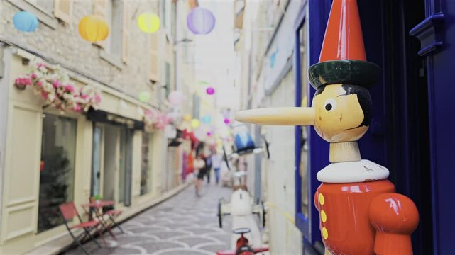 Pinocchio sculpture made out of wood on the streets of Antibes, France
