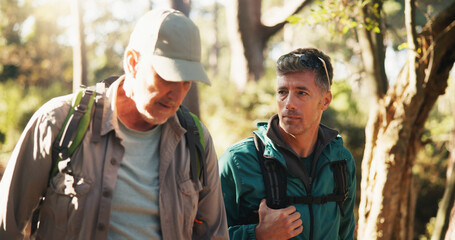 Fototapeta premium Fitness, hiking and man friends in forest together for exercise, health activity or hobby. Conversation, summer and wellness with hiker people outdoor in nature or woods for backpacking and trekking