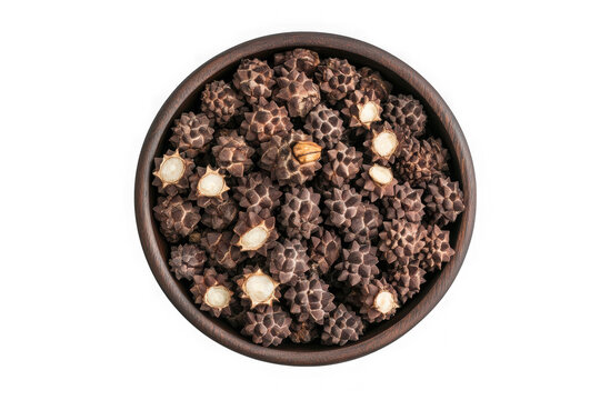 Bowl full of dried water caltrop fruits trapa natans healthy food ingredient asian cuisine isolated on transparent background