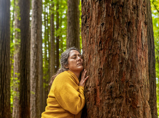 Woman Embracing Tree in a Forest of the Great Ocean Road, Australia