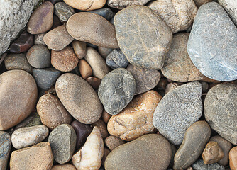 Abstract background of stones of different shapes and colorful pebbles