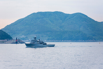 A South Korean navy frigate in grey camouflage returns to base after a coastal patrol mission near...