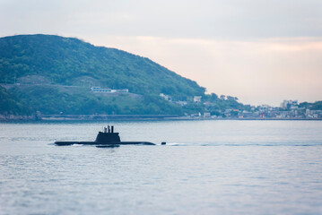 A South Korean submarine cruises along the coastline at sunrise, returning to base after completing...