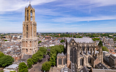Clear view of missing cathedral nave between De Dom church tower and the gothic architecture of the Utrecht diocese ambulatory and transept. Holland religious tourist destination seen from above.