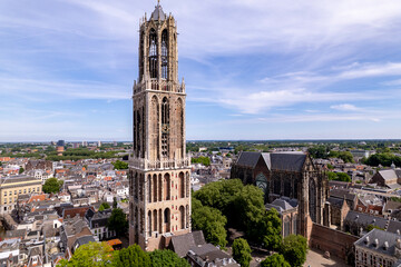 Full view of De Dom tower in medieval center of Utrecht, The Netherlands, rising above historic diocese town