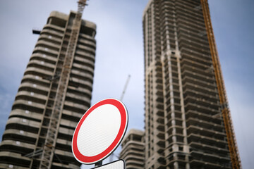 Tall building under construction against blue sky