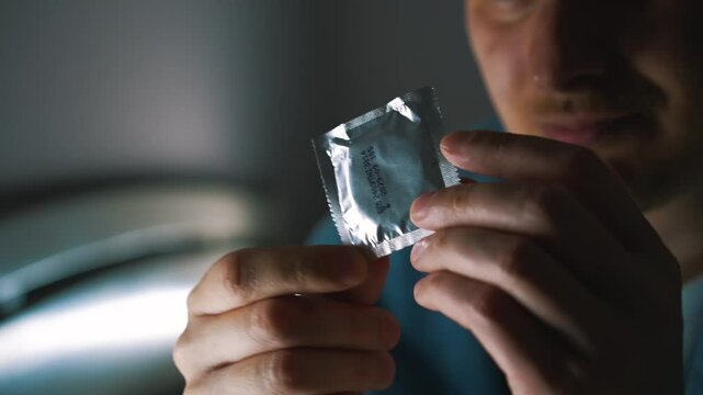 A man demonstrates that it is necessary to use condoms.
Condom advertising.
Safe sex life and risks of sexually transmitted diseases.
Sex, intimate, hand, condom