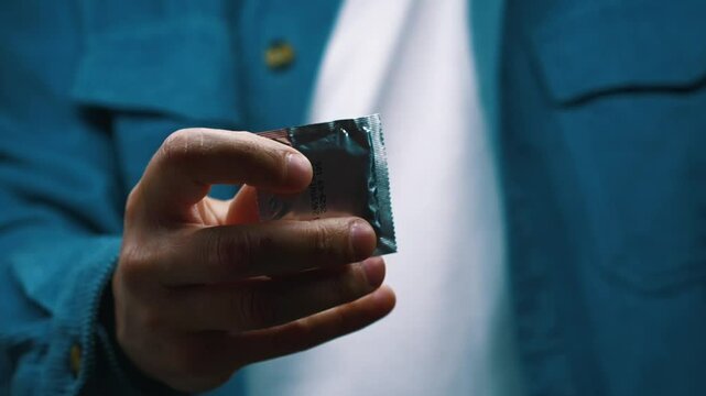 A man demonstrates that it is necessary to use condoms.
Condom advertising.
Safe sex life and risks of sexually transmitted diseases.
Sex, intimate, hand, condom