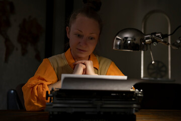 Writer reflecting on manuscript in dimly lit workspace with typewriter and focused expression