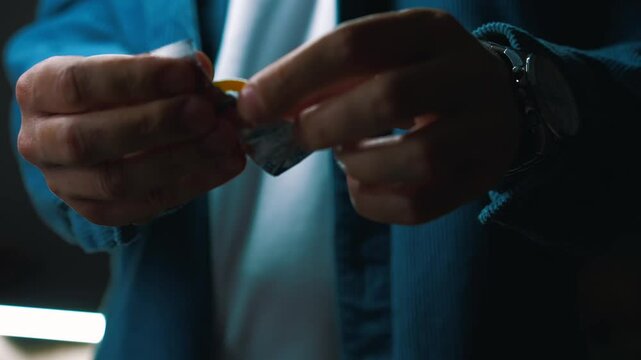 A man unpacks a condom before using it in an intimate setting.
Safe sex and health.
Health of the genital organs.
Sex infections