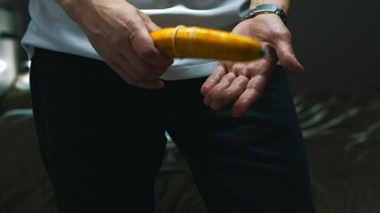 A man with a banana and a condom shows how to protect himself from unwanted pregnancy and sexually transmitted infections.
Aborted pregnancy.
Safe sex.
Intimacy, pregnancy, abortion, sex