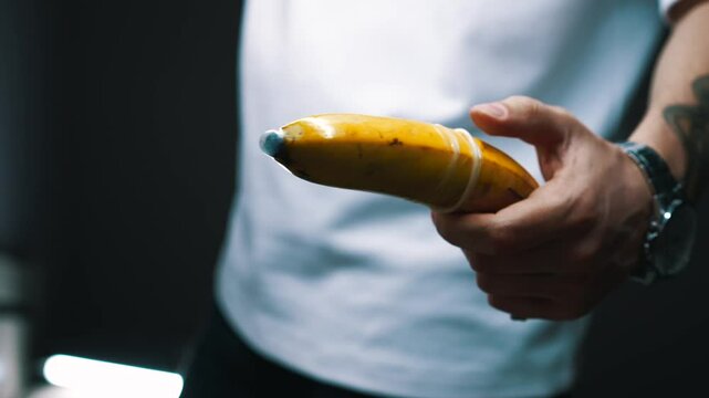 Using a condom.
The man put on a banana condom.
Sexual relations and protection from venereal infections.
Unprotected sex and health risks