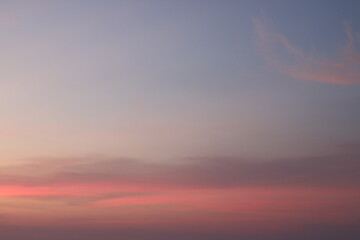 Gradient sky at twilight, painted with soft hues of pink, lavender, and dusky blue. Wisps of clouds streak across the upper right, creating a calm and ethereal atmosphere.