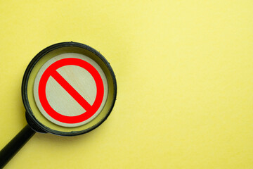 Magnifying Glass Focused on No Entry Symbol, Signifying Forbidden Areas, Restricted Access, and Safety Measures for Security, Caution, and Public Safety Graphics.