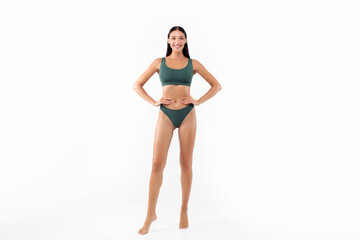 Sensual lady posing in green underwear isolated on white studio background, showing ideal body figure, full body length, copy space © Home-stock