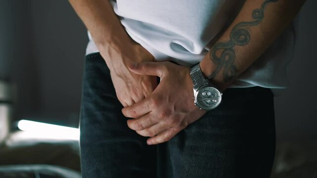 A man holds his penis with his hands demonstrating problems with the genital organ and sexually transmitted disease.
Problems with urination and going to the toilet