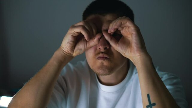 A young man imitates binoculars with his hands and looks into the distance.
A man looks through binoculars.
A man has taken glasses or binoculars from his hands and is looking somewhere