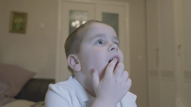 Child Opens His Mouth To Show Wiggling Baby Tooth. Child Showing His Milk Tooth Before Losing It. Permanent Tooth Replacement.