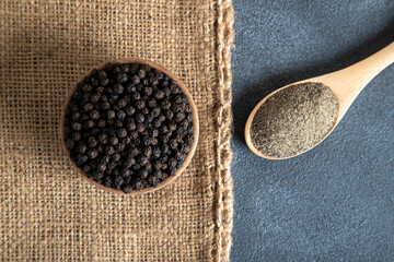 Ground black pepper with grains of black pepper on top view