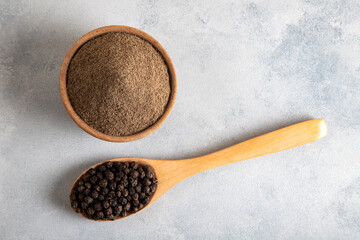 Ground black pepper with grains of black pepper top view