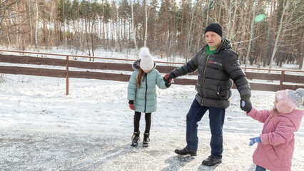Little girls with her grandfather walking in park on snowy winter day