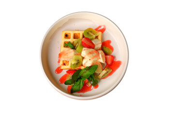 Waffle with kiwi, strawberry, banana, sauce, and mint in a white plate, a cropped PNG object.