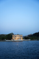Kucuksu Pavilion at sunset on the edge of the Bosphorus with blue sky