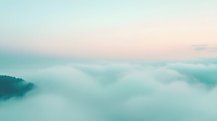 Fototapeta premium Glimmering mists embracing a mountain aerial view landscape photography foggy atmosphere pastel mint tones