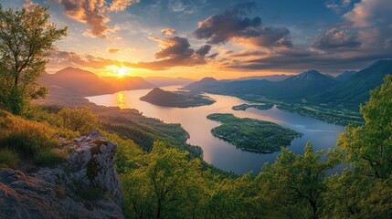 A panoramic view from a mountain peak, where the sunset illuminates the winding rivers, forests, and ocean below