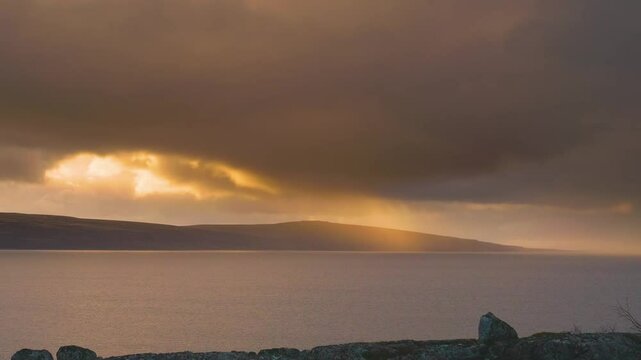 Peaceful early morning sunrise scene at Lough Foyle from Quigley's Point, showing calm water reflecting pastel sky colors and quiet Irish landscape.