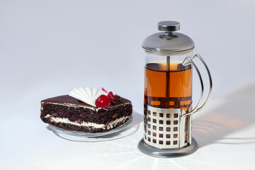 Teapot with metal strainer inside. Kitchen utensils on gray background.
