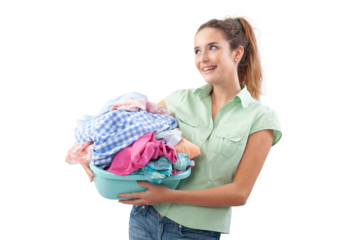 Smiling woman holding plastic laundry basket filled with dirty laundry, isolated on white background. Concept of household chores, laundry day, domestic work and clothing care or Laundry services