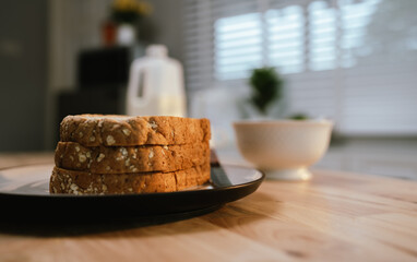 A woman enjoys a peaceful morning, spreading fresh strawberry jam on bread during breakfast—homemade, healthy, and full of natural sweetness.
