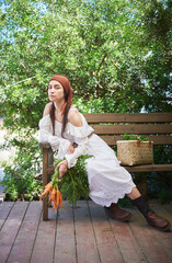 portrait of young woman with dark hair in white dress on farm in summer