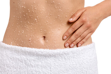 Woman applying body scrub onto her belly against white background, closeup