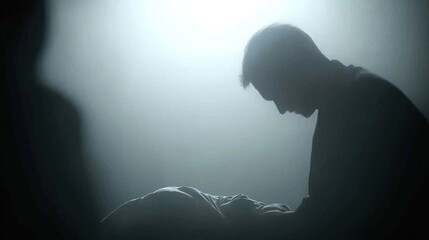 Man grieving with dimly lit room.