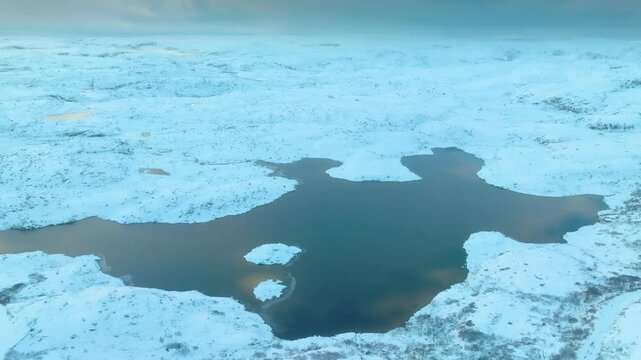 Aerial view showing the vast glacier at Musta - Tunturi Ridge, with detailed ice formations and the slow glacier flow in the Kola Peninsula region.