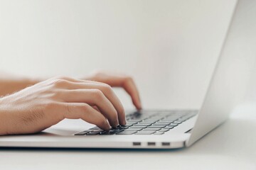 Hands typing on a laptop surrounded by a digital shield icon, symbolizing cybersecurity and technology.