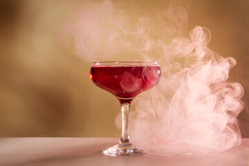 Red alcoholic cocktail on beige background. Alcoholic drink