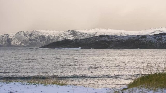 Winter footage of Hadsel Bridge spanning the cold waters in Nordland, Norway, part of the Vester&aring;len archipelago covered in snow and icy atmosphere.