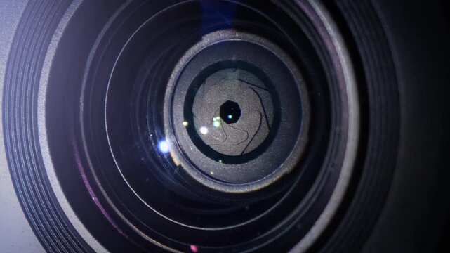 close-up of a camera lens with the aperture opening and closing