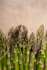 Bunch of fresh green asparagus on stone surface copy space